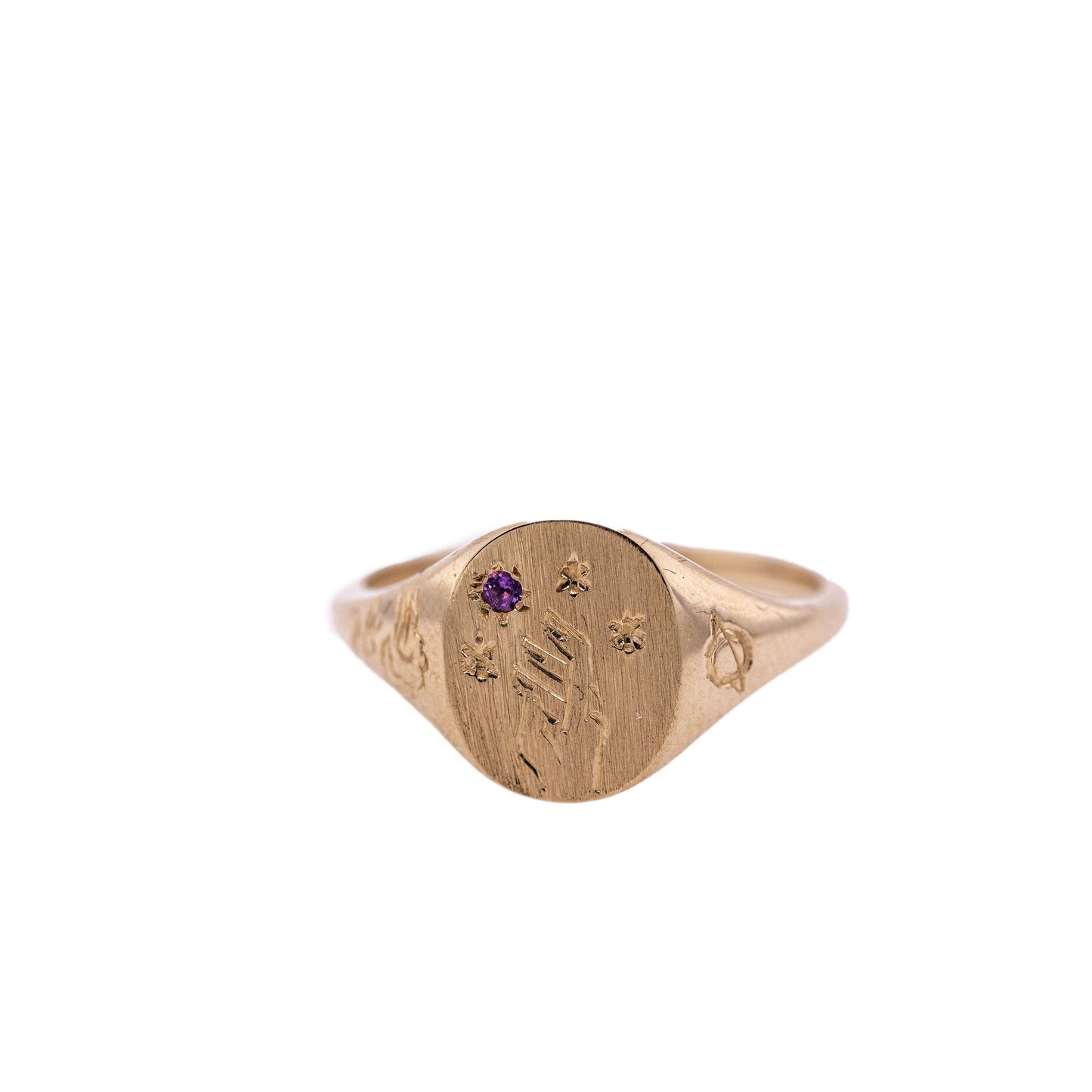 Amethyst Hand-engraved gold signet ring with intricate design on a clean white background