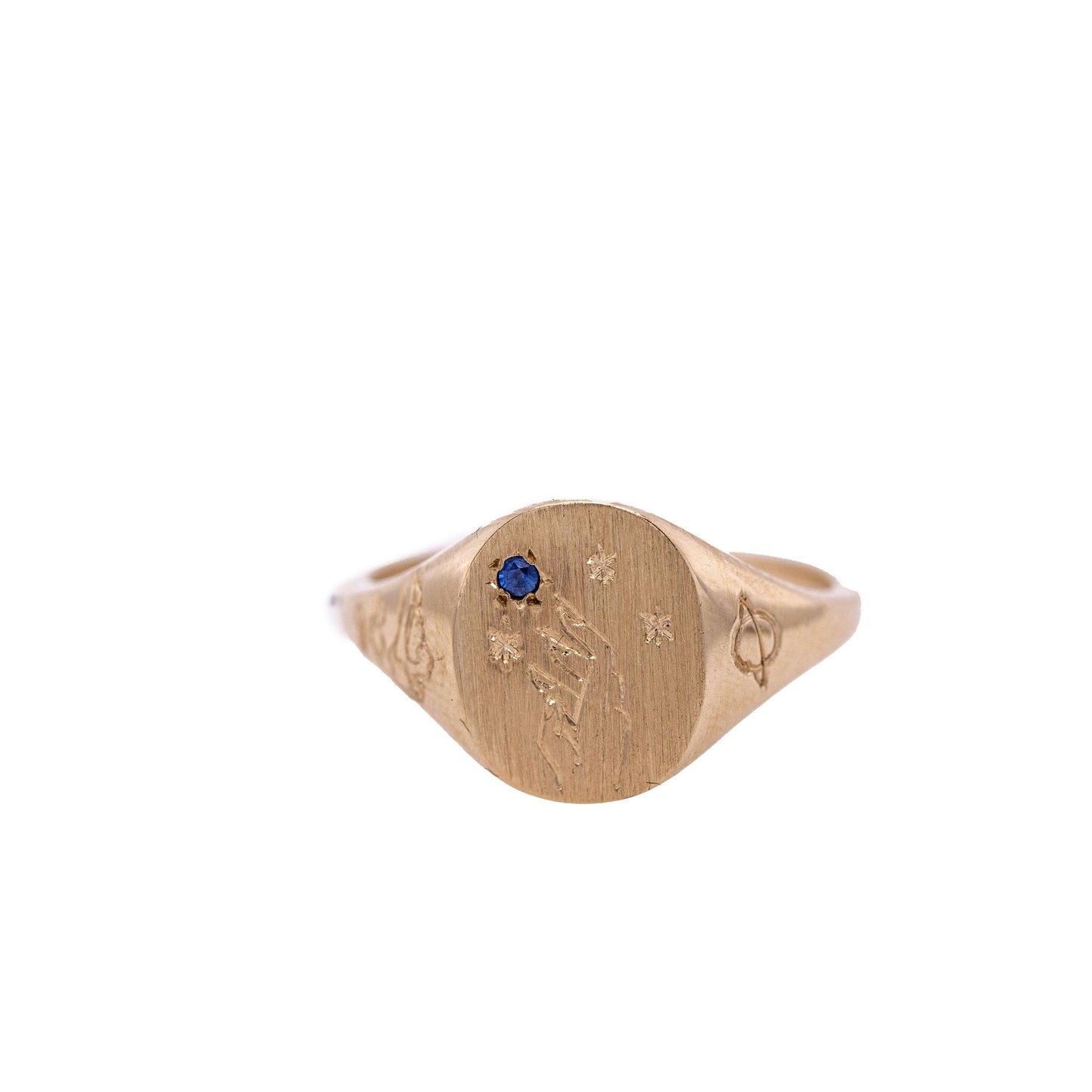 Sapphire Hand-engraved gold signet ring with intricate design on a clean white background