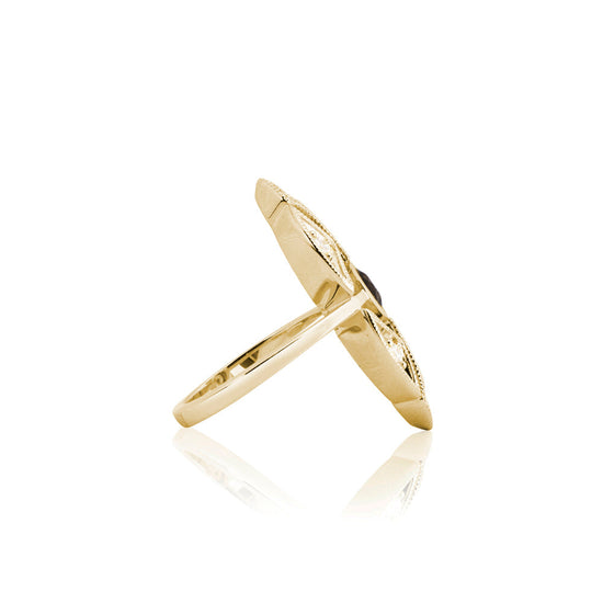 profile shot of gold medallion ring