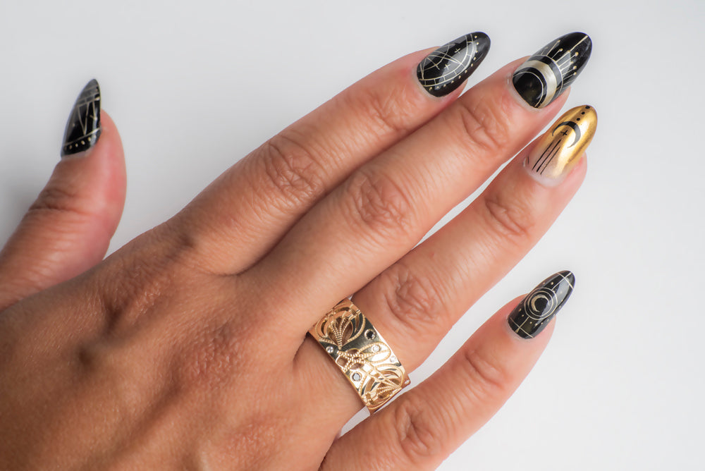 yellow gold cigar band with diamonds photographed on a model's hand